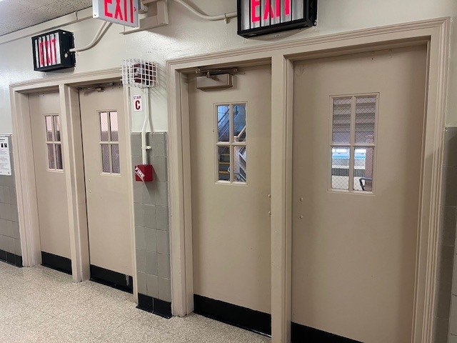 Plain stairway doors before the mural